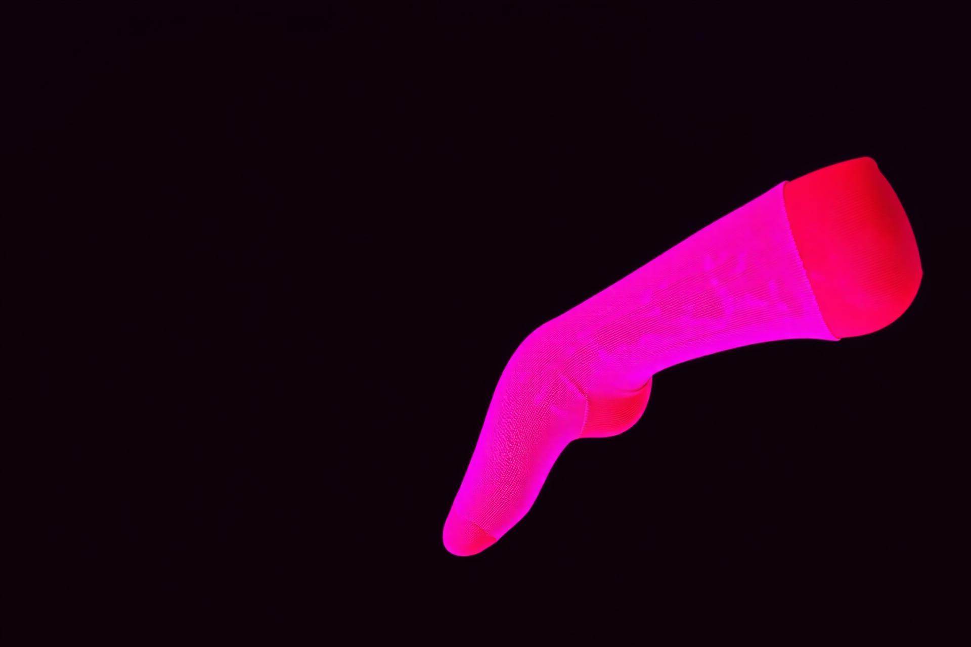 Glowing pink sock on black background